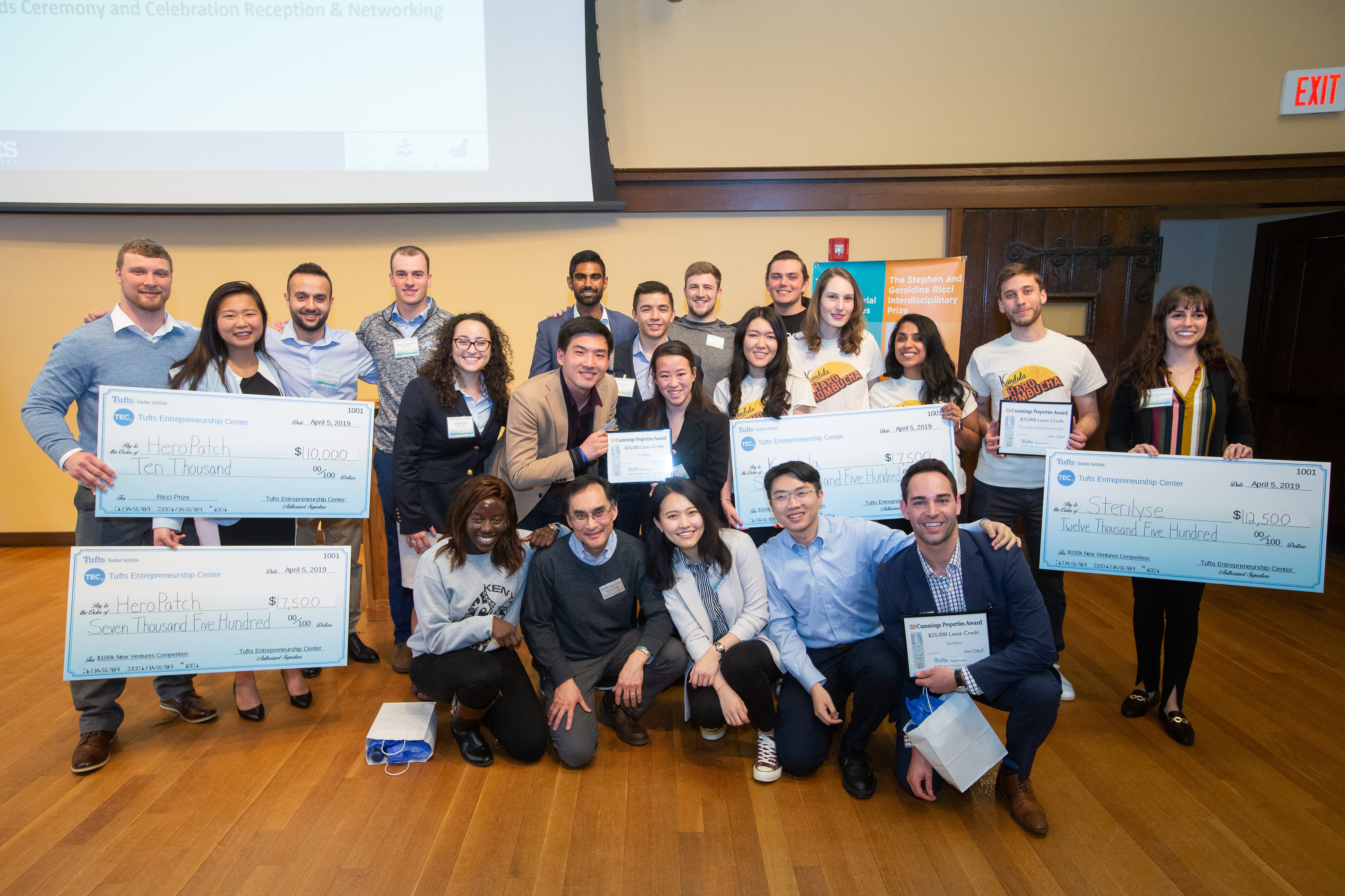 Photo of MSIM Winners in the 2019 Tufts $100k New Ventures Competition holding large checks