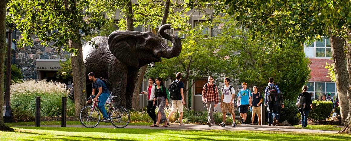 Jumbo elephant statue on Tufts campus with students walking by
