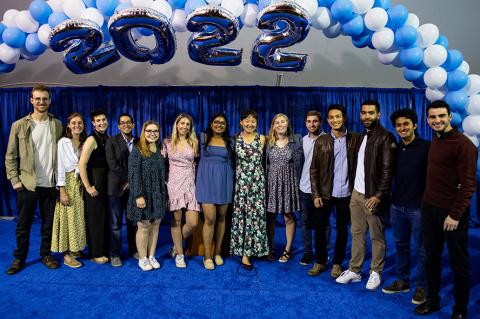 Tufts Gordon Institute students posing for picture beneath "2022" balloons