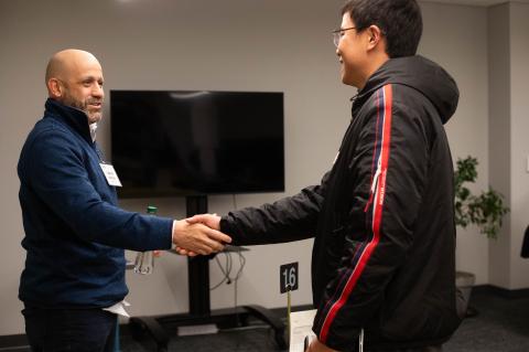 student and mentor shaking hands
